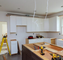 In a set of furniture under construction, white kitchen wooden cabinets were installed with a home improvement view
